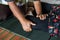 Close-up view of both hands of an elderly Thai female masseuse squeezing and bending the legs