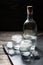 Close-up view of bottle vodka with glasses standing on ice black