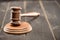 Close-up view of brown mallet of judge on wooden table