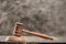 Close-up view of brown mallet of judge on wooden table on grey