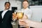 Close-up view of business team of multinational employees holding clinking glasses of champagne