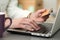 Close up view of businesswoman hands holding credit card and making online purchase