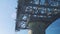 A close up view of cable car or aerial tramway pylon on bright blue sky and sea.