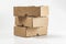 close-up view of cardboard boxes on white background - stacked small brown cardboard boxes