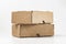 close-up view of cardboard boxes on white background - stacked small brown cardboard boxes