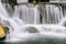 Close up view of cascading water falling over the rocks at Longshan Buddhist temple in Taipei city, Taiwan