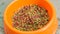 Close up view of cat diet food in a orange bowl