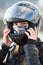 Close up view at Caucasian woman motorcyclist wearing crash black helmet on head