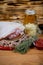 Close up view of chef cooking Bavarian pork knuckle with glass of beer and sauerkraut, thyme and paprika. cooking recipe photo