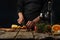 Close-up view of chef cuts apple on wooden board fore preparing mulled wine on rustic wooden table with festive composition