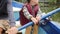 Close up view of child`s hands holding wooden paddle. Little child`s hands hold paddle. Adorable little boy rows on boat on lake i