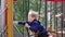 Close up view of children playing on playground in park and adults watching after them.