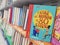 Close-up view of a children`s book cover, thick shelf of children`s books