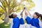 close up view of children soccer team arms in the air with cup