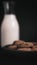 Close up view of  chocolate chip cookie on a plate with crumbs with a bottle of milk in the background simple morning snack