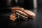 Close-Up View of Chocolate-Coated Sandwich Cookies on Dark Background