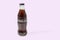 Close up view of Coca Cola in a glass bottle isolated on pink background.