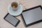 Close up view of coffee, tablet and cell phone on wooden background