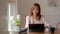 Close up view of college girl concentrating on her assignment with digital tablet, coffee cup and stationery