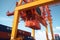 Close up view of container ship under loading. Freight vessel at the berth in cargo terminal. Port cranes loading