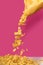 Close-up view of corn flakes pouring out from bag