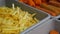 Close up view of counter with nuggets, fried fries, chicken wings at the street fast food festival