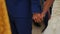 Close up view of couple holding hands having wedding ceremony in church.