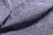 Close up view of crumpled, grey wool fabric background, Jammed light gray classic cotton