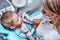 Close up view of a cute little kid doing teeth surgery by a pediatric dentist