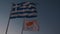 Close up view of Cyprus and Greek flags waving in wind against blue sky. Cyprus and greet flags in sunset sky