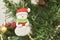 Close-up view of a decorated Christmas tree, friendly snowman hanging