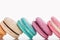 Close up view of delicious colorful French macaroons of different flavors on white background.