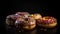 Close-up view of delicious stack of chocolate glazed donuts with various toppings.