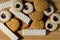 Close up view of different cookies on wooden background .