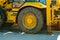 Close-up view of a dirty wheel of yellow heavy earth mover