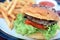 Close-up view, Easy homemade burgers with blurred french fries is background.