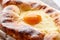 Close up view of egg yolk on adjarian khachapuri.