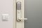 Close up view of an electric combination lock on a white door. Interior design.