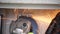 Close-up view of an electrician saws off a bolt with a grinder in a electricity power shield, fuse box, an industrial