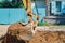 Close up view of an excavator bucket full of earth. The process of digging soil at a construction site. Window of an old