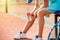 Close up view of an exhausted tennis girl resting on a plastic chair, no face