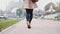 Close-up view of female foot. Young stylish woman walking near the Eiffel tower in Paris, France early in the morning.