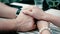 Close-up view of female smooth hands with manicure and pearl bracelet hugging and stroking male hands with watch on