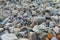 Close-up view of a field of rocks and pebbles with colorful hearts painted on one rock