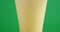 Close up view of a fizzing pint of beer for st patrick on green background