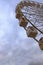 Close-up view of fragment of a Ferris wheel and a stormy sky and gloomy clouds. Rainy weather in spring. Kyiv, Ukraine