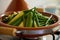 Close-up view of fresh organic eco vegetables steaming in clay pot dish. Preparing traditional Moroccan tagine