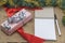 Close up view of gifts packed in holiday boxes lying with pen and book desktop. Christmas holiday concept.