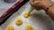 Close up view of girl making cream puff pastry ball using the piping bag in a row