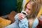 Close-up view of a girl with a mug of coffee in her hands.